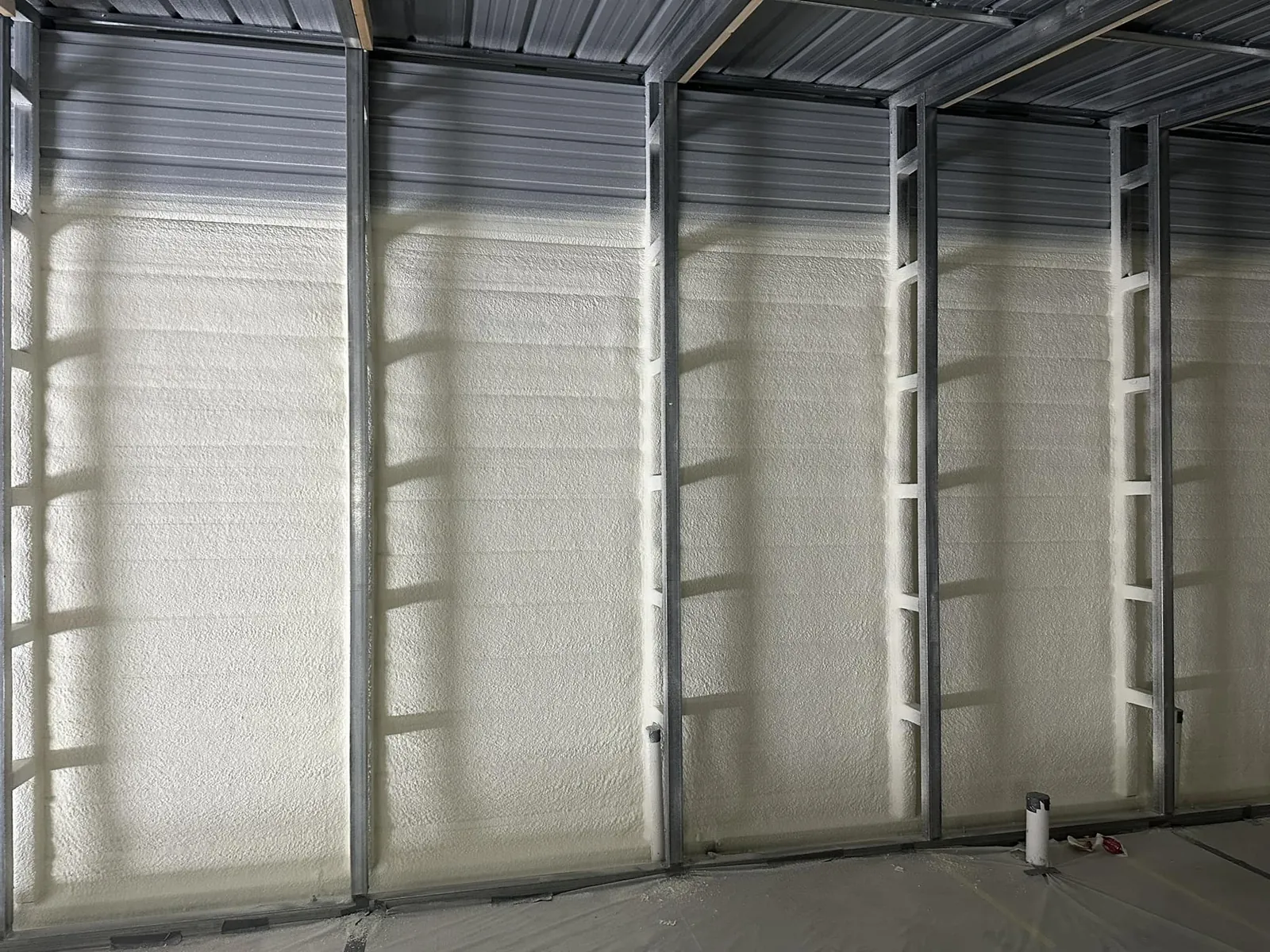 Spray foam insulation applied in a metal building